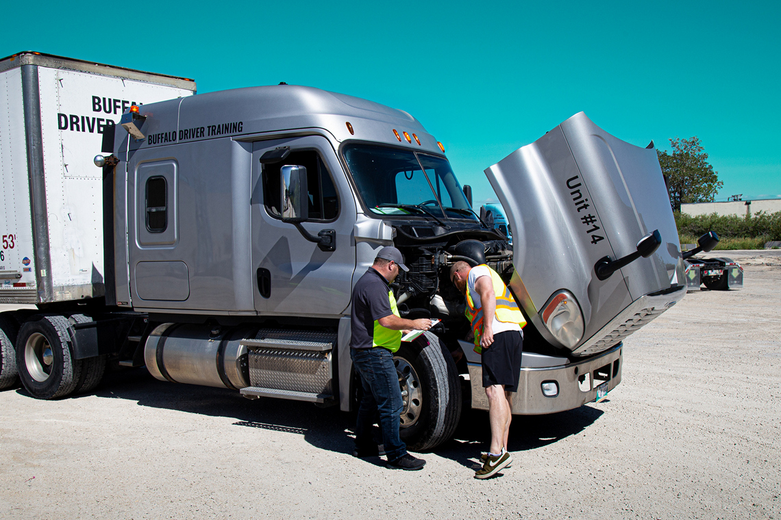 An instructor and student practising a truck inspection at Buffalo